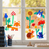 Fensterbild mit Waldbewohnern aus dem Bastelset, darunter Fuchs, Igel, Maus sowie bunte Blumen und Pilze, dekorativ am Fenster angebracht