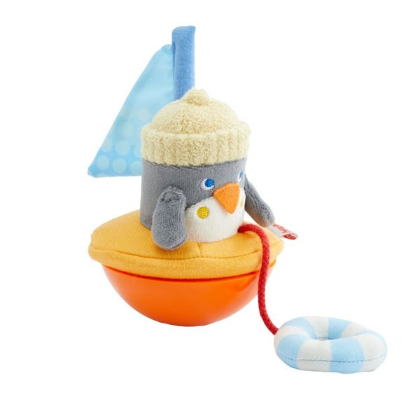 Stehaufpinguin von HABA mit Schwimmring und Fahne
