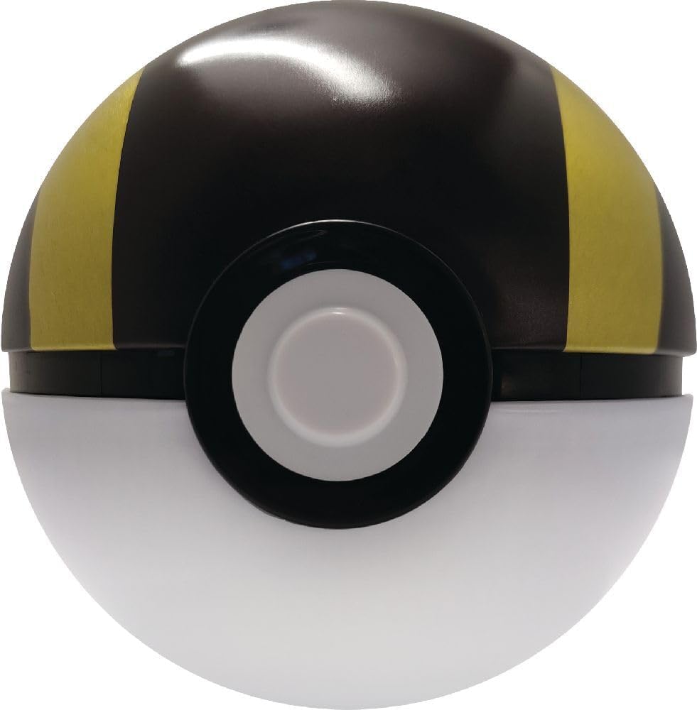Pokémon Pokéball Tin Box mit Münze und Boostern auf Tisch
